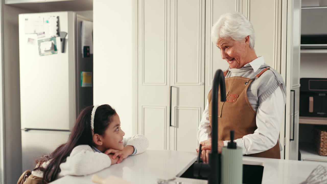 Grandmother and granddaughter high five in the kitchen