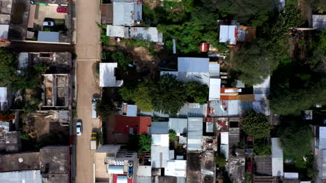 aerial close-up view of the city of oaxaca in mexico, filmed by a drone with top down displacement, showing a poor area and shack homes