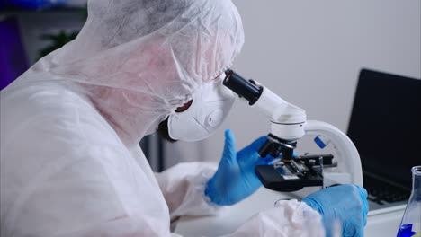 scientist using a microscope in a laboratory setting