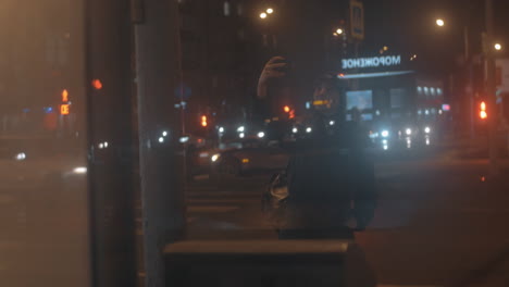 woman taking selfie against night city