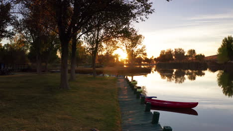 park lake at sunrise over dock