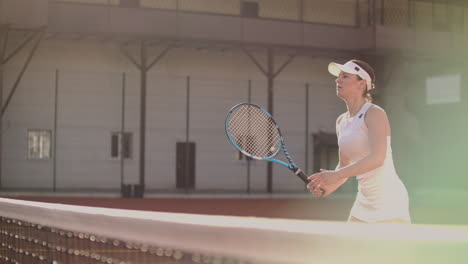 tennis game on sunny day at tennis court young sportive woman playing.