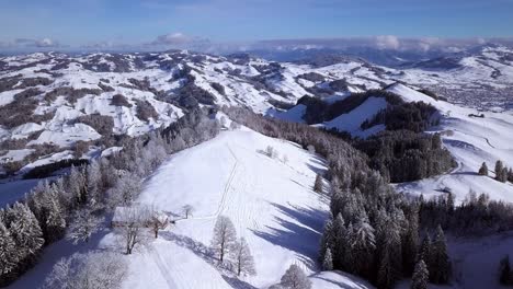 panorama of the rugged snow covered hundwiler hoehe, swiss alps, aerial rise