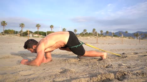 athlete practicing drag on elbows with resistance at sunrise