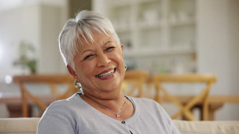happy, face and senior woman on sofa in home