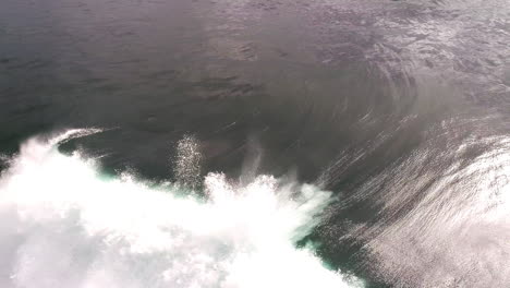 sunrise wave curls in slow motion with glowing highlights and soft misty spray