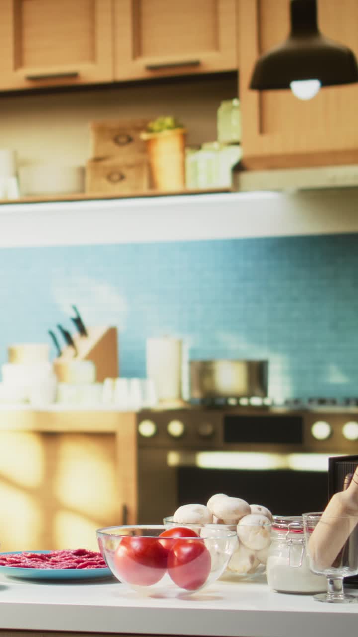 Vertical Video Comfortable kitchen setup with pizza ingredients on a modern countertop