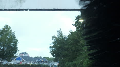 an automated car wash machine in operation as seen from the inside of a motor car