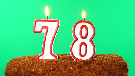 cake with the number 78 lighted candle. chroma key. green screen. isolated