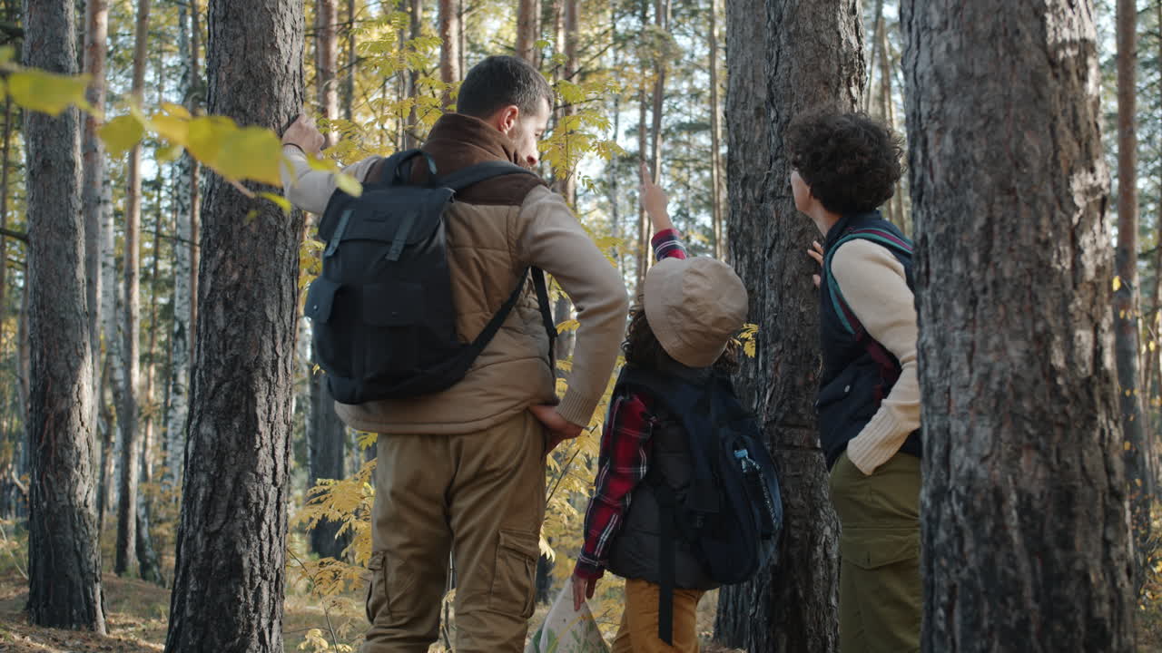 Family Hiking in Autumn Forest