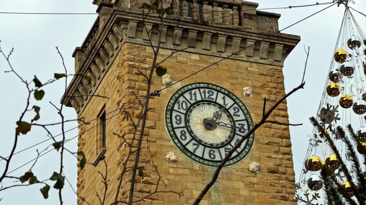 Historic clock tower with festive Christmas lights in Bergamo, Lombardy, Italy