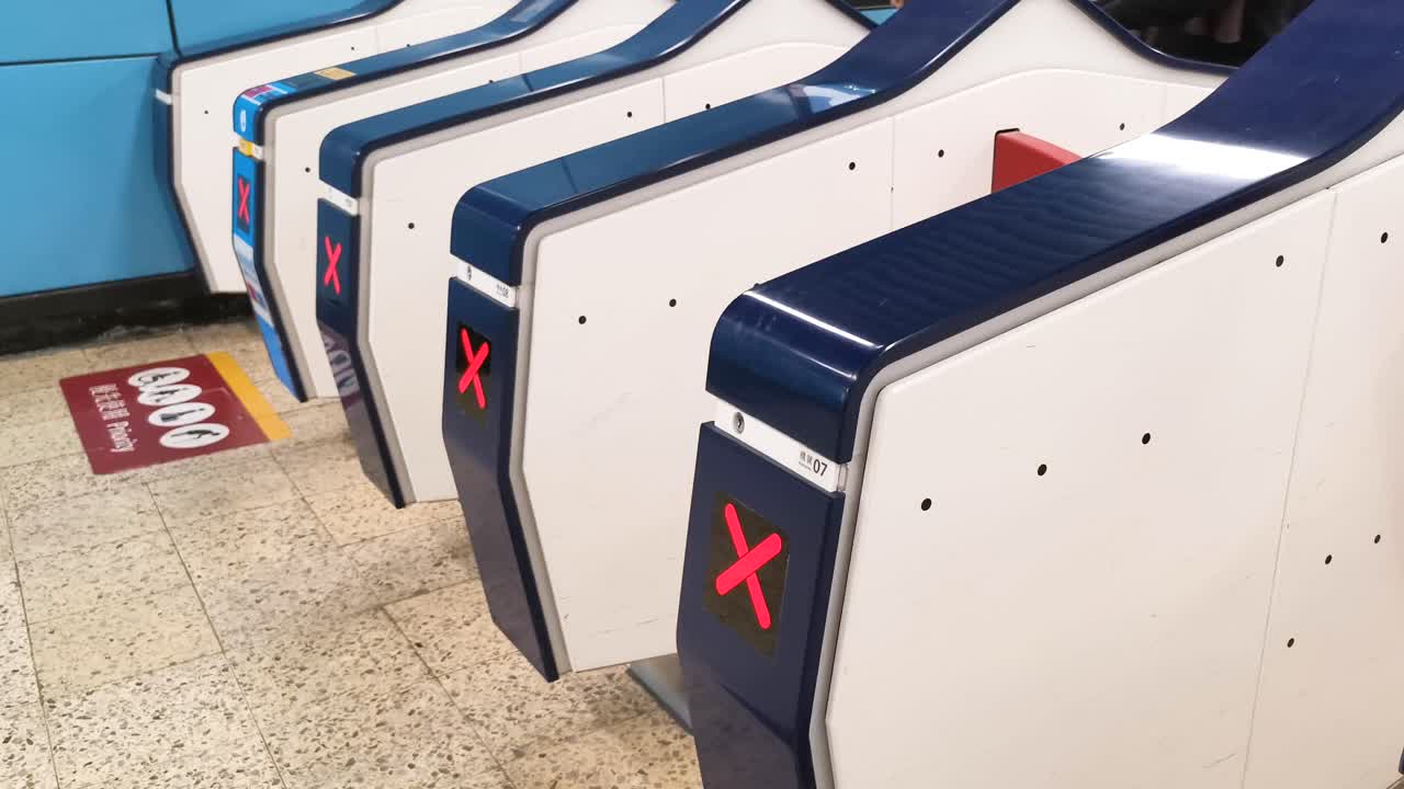 Passengers going through ticket gate in Kowloon Tong MTR Station, Hong Kong. 12 March 2019