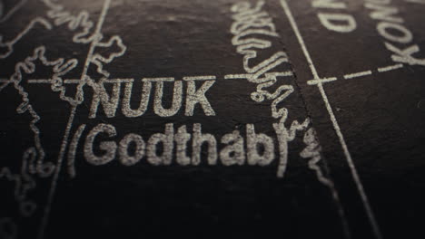close-up of a world globe showing nuuk, greenland