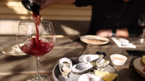 red wine being poured into a glass