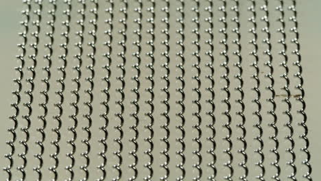 close-up view of a metal mesh with a repeating spiral pattern