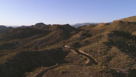 AERIAL---Desert-Mountain-Road-During-Golden-Hour