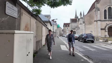 statue memorial jean moulin, a church, and street view over towers of cathedral our lady of chartres, france