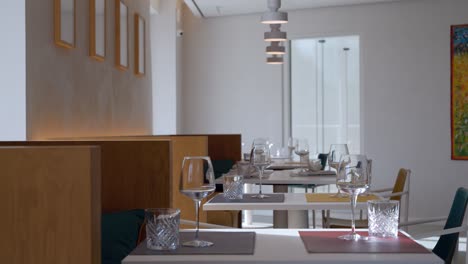 elegant interiors of restaurant with empty chairs and glasses,slider shot