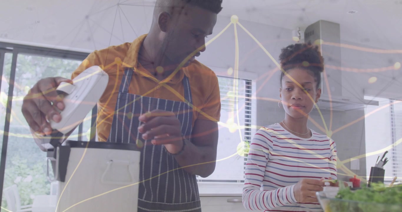 Man operating blender opening lid adding herb while woman inspecting, overlay nodes showing cooking
