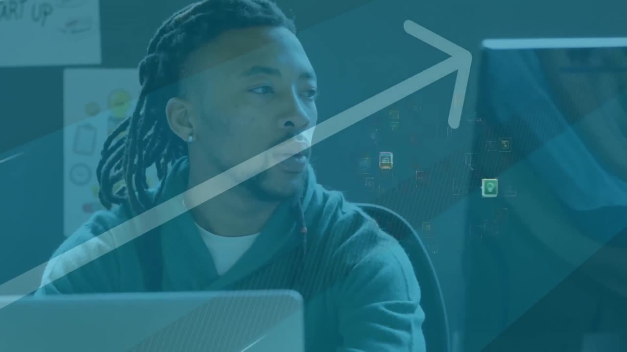 Animation of network of connections and media icons over businessman at desk using computer