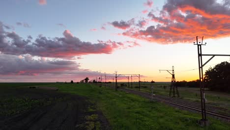 Beautiful-sunset-aerial,-drone-shot-of-railway-tracks-in-the-farmlands-of-the-Free-State,-South-Africa