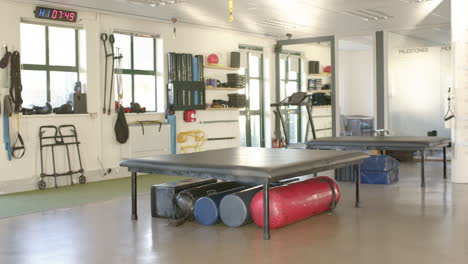 rehabilitation center gym with equipment for physical therapy and disability rehab, copy space