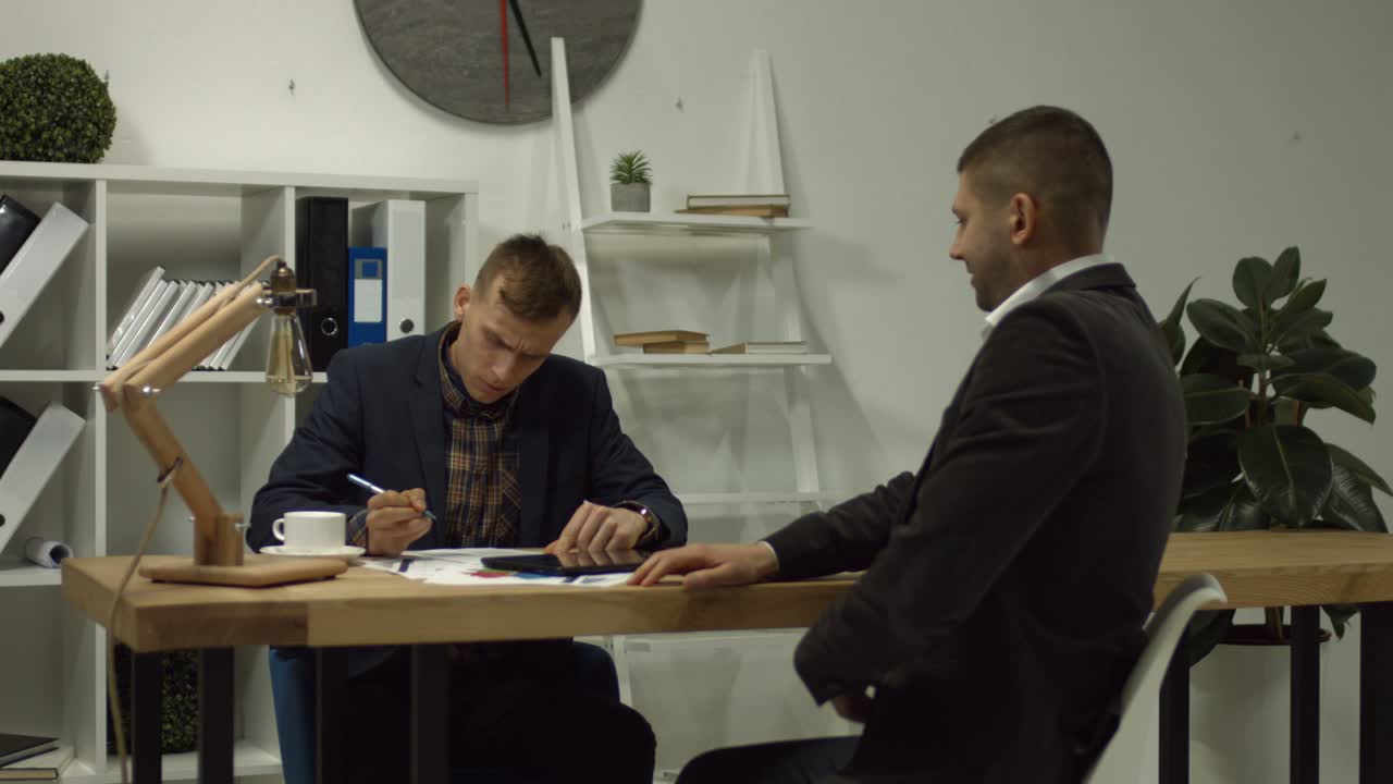 Man dealing with a financial adviser at the office