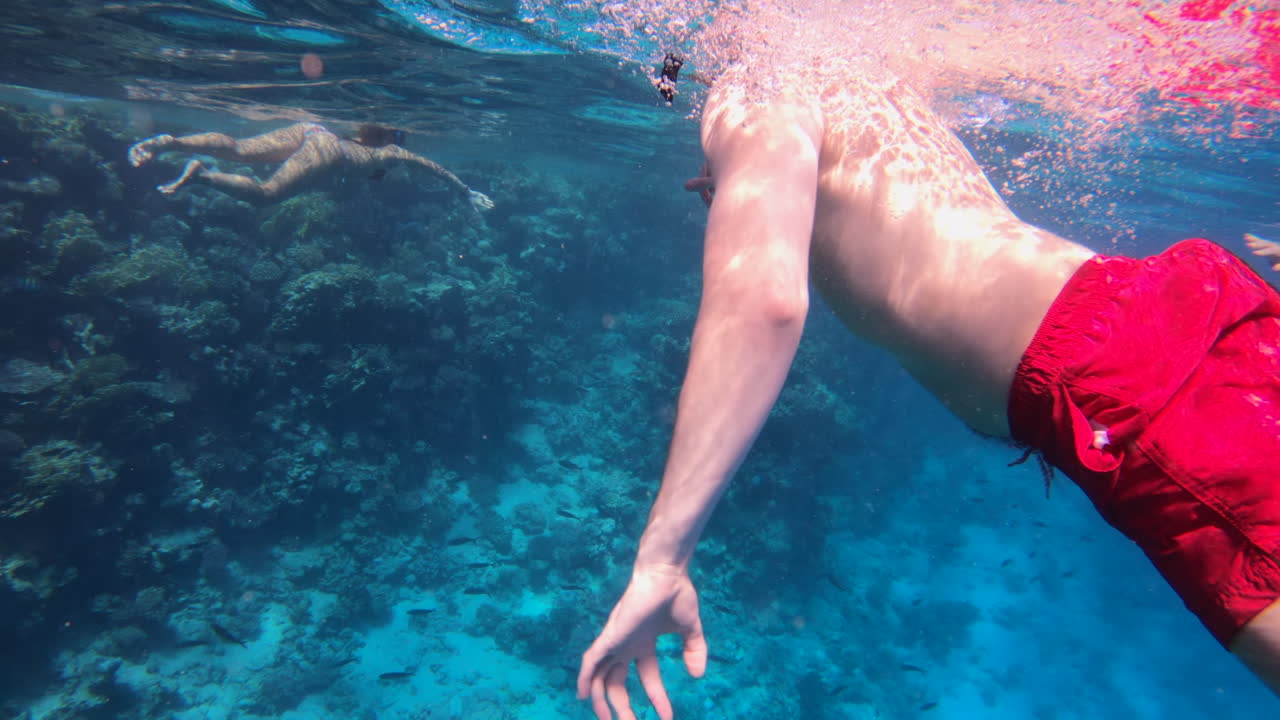 Man swimming and exploring in the red sea