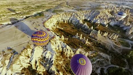 witness a magical sunrise above cappadocia's unique landscapes from a colorful hot air balloon.