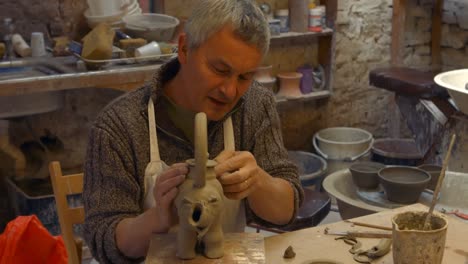 potter working on clay sculpture