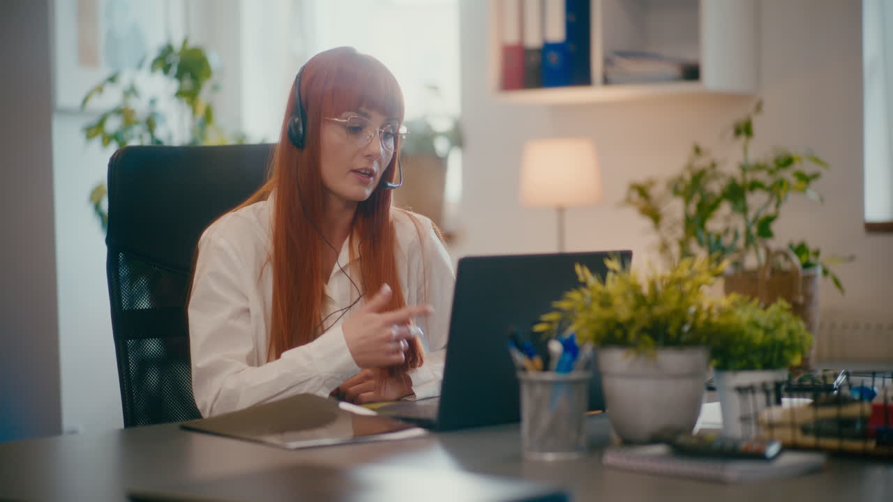 Customer representative working on laptop in office.