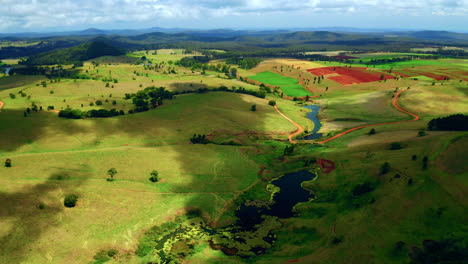 clouds shade moving in the green fields and creek in rural area of atherton in qld, australia