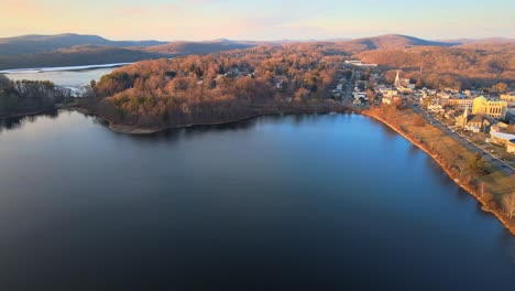 aerial drone footage of lakes, hills, mountains, and forests during sunset in the appalachian mountain during winter