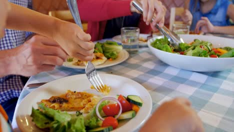 family having meal together in restaurant 4k