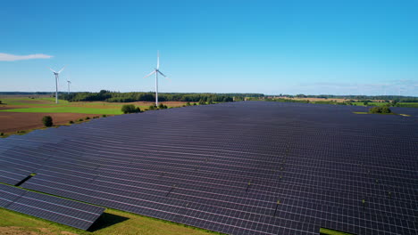 Solar-Panels,-Wind-Turbines-in-a-Green-Field,-Aerial-View,-Poland