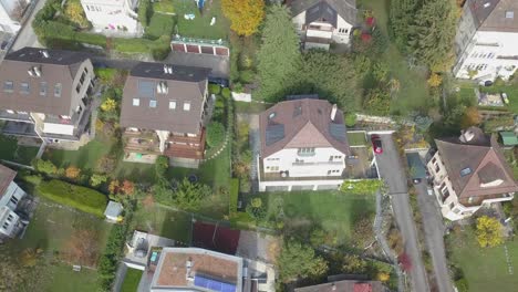 lausanne, residential neighborhood viewed from the sky, houses with tile rooftops drone aerial view, urban environment, switzerland, vaud