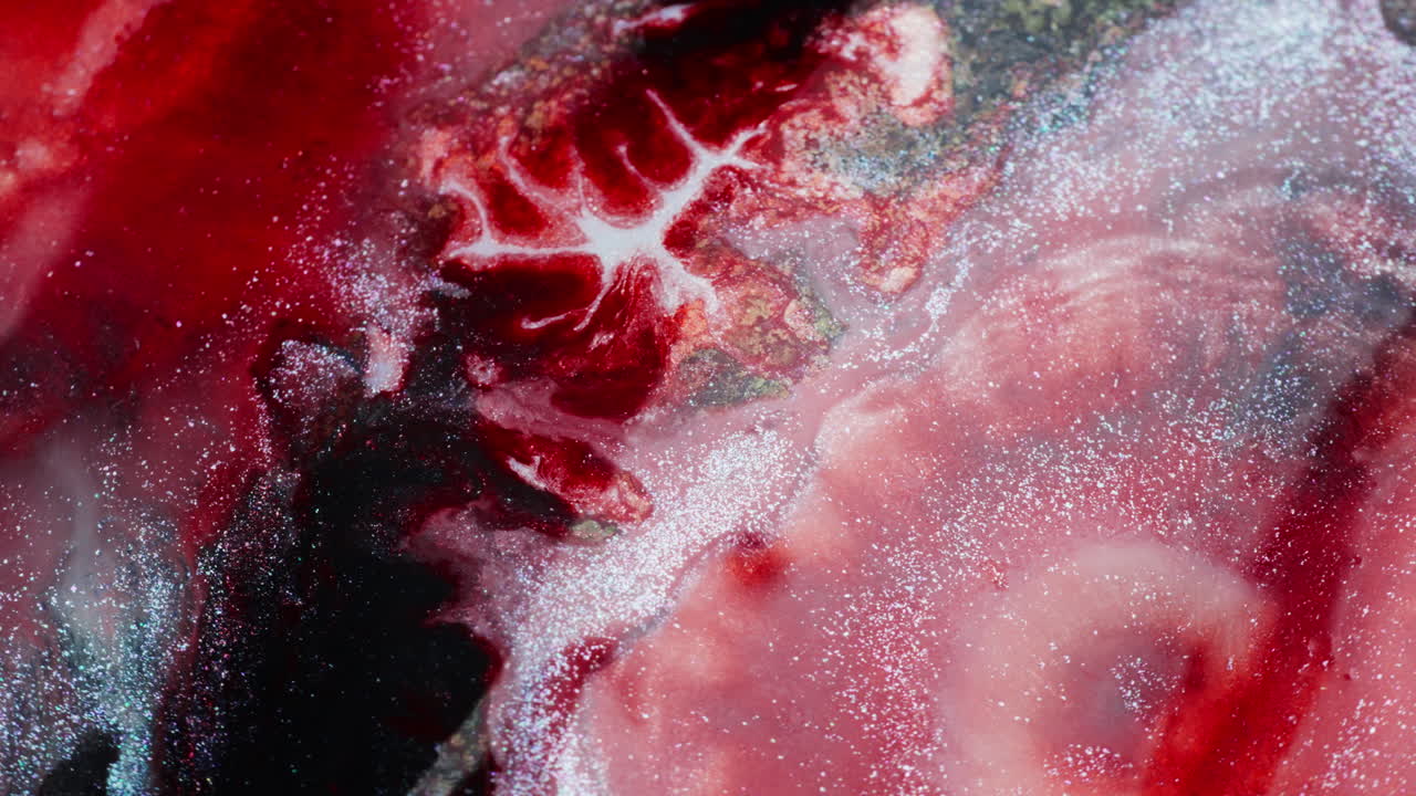 Intense wine-red ink moving in an abstract macro backgrounds