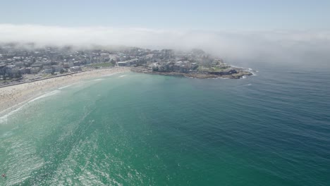 Fog-Clouds-Blanket-Suburb-At-Crowded-Bondi-Beach-In-Sydney,-Australia