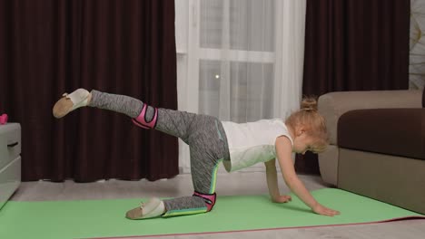 Child-kid-training-gymnastics-stretching-at-home,-children-girl-making-sport-workout-exercises