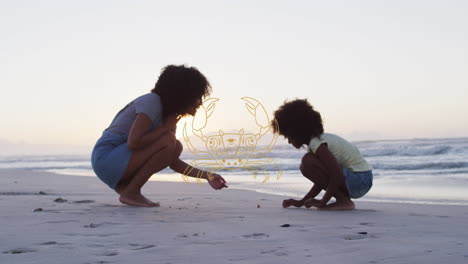 animación de cáncer sobre madre e hijo afroamericanos recogiendo conchas en la playa al atardecer