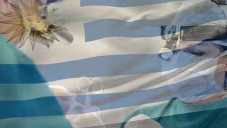 Animation-of-flag-of-uruguay-waving-over-surgeons-in-operating-theatre