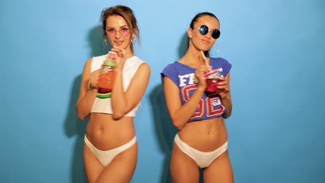 two women enjoying summer drinks