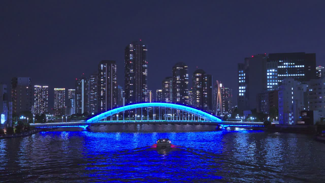 Cityscape at Night with Illuminated Bridge and Buildings