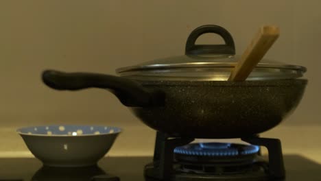 closeup of stove cooking food in pot in kitchen at home