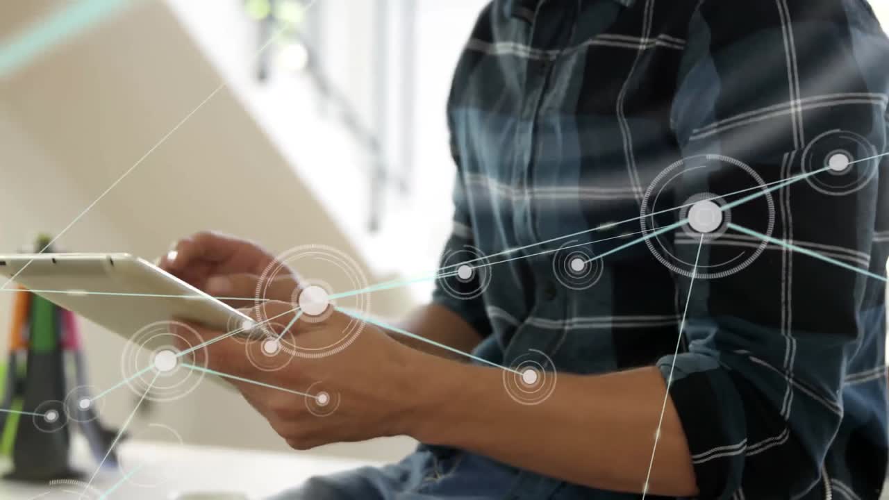 Animation of network of connections over mid section of man using digital tablet at home