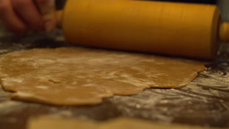 flattening gingerbread dough with rolling pin