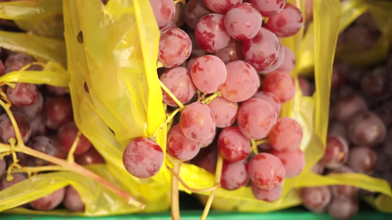 Close-up of red grapes in a yellow bag