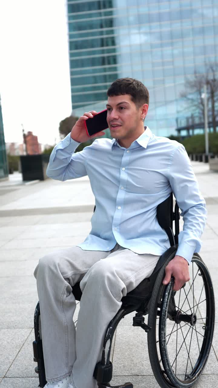 Professional Man in Wheelchair Talking on Smartphone Outdoors