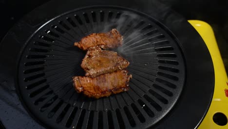 slices of smoked grilled meat on a grilling plate prepared for lunch - close up shot