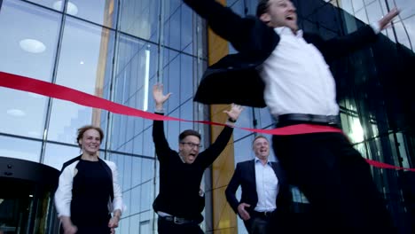 business people crossing the finish line